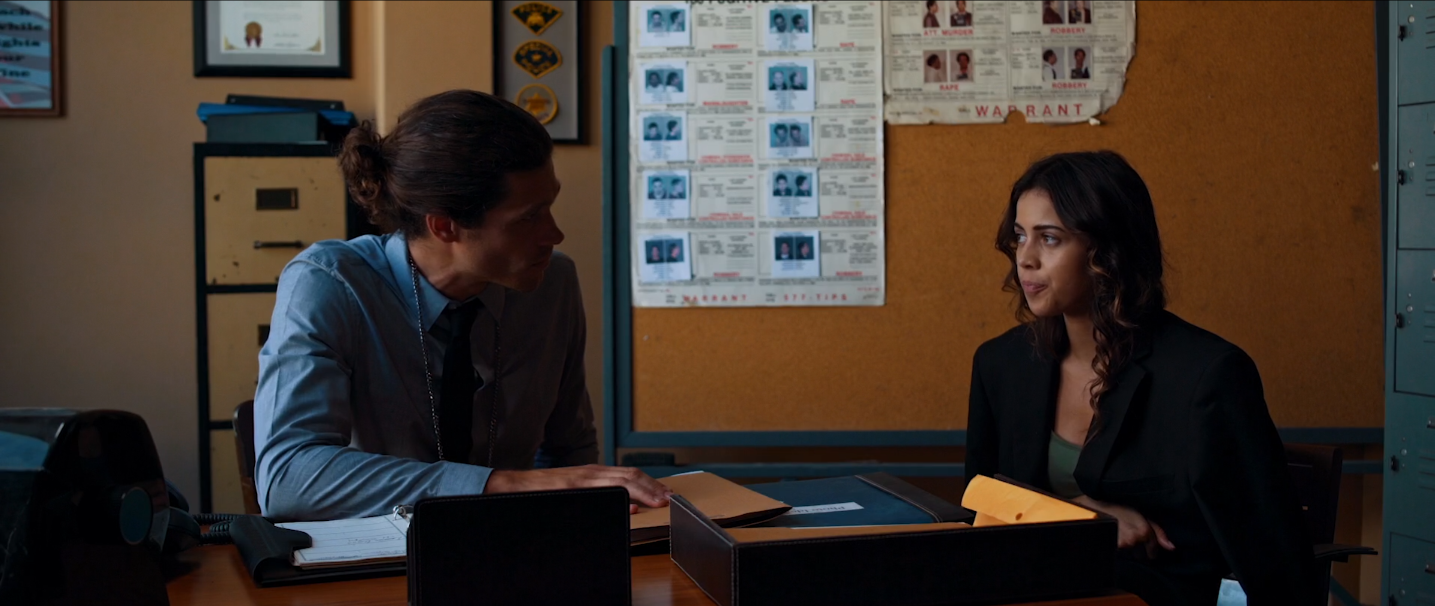 Detective's office in Avenge the Crows with a case board of photographs behind the desk