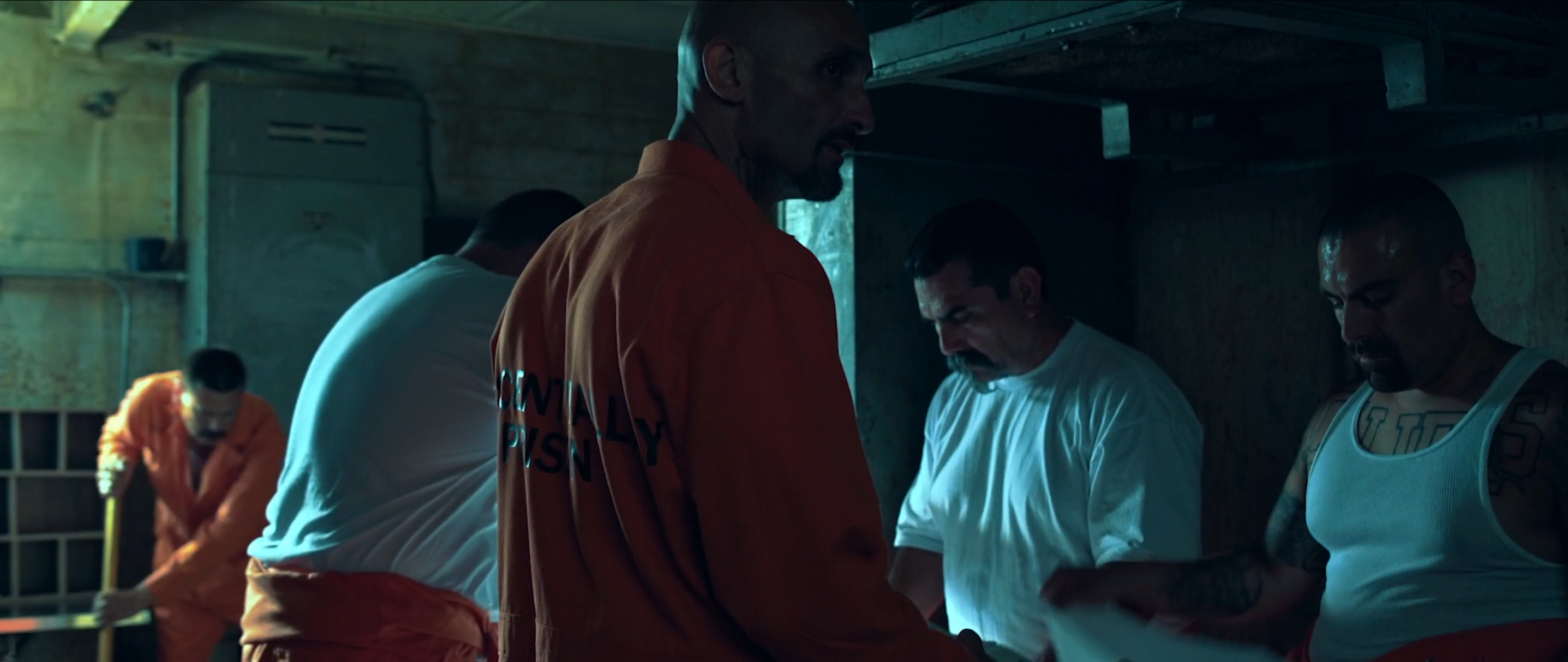 Teal-lit industrial prison interior in Avenge the Crows