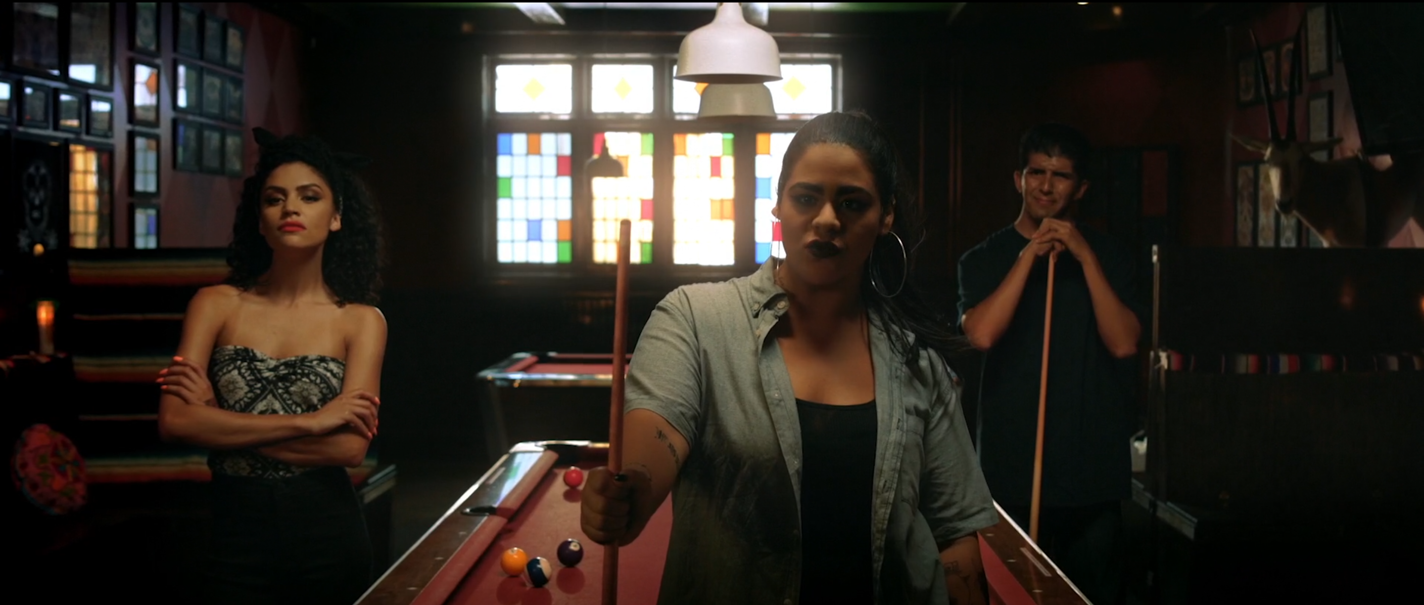 Pool hall in Avenge the Crows, stained glass windows and a low lamp hung over the table