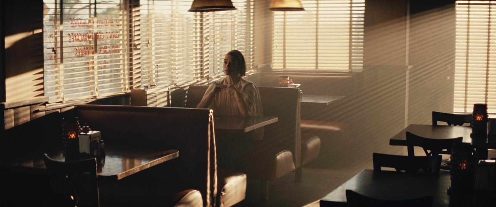Mid-century office with venetian blinds in warm sunlight, Edge of Space, production design by Myra Barrera