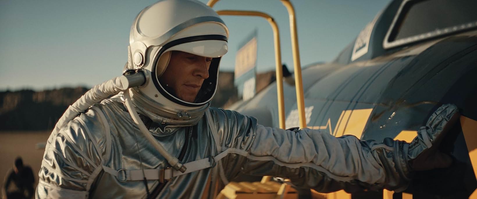 Pilot in a silver pressure suit climbing into the X-15 cockpit at golden hour, Edge of Space