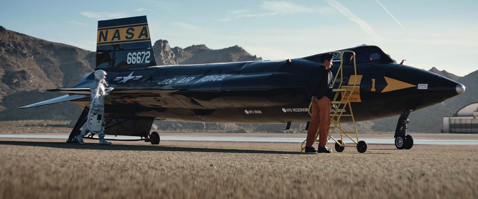 NASA X-15 rocket aircraft on the desert lakebed with a pilot in orange flight gear, Edge of Space