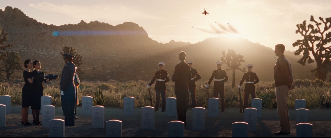 Desert military cemetery at sunset with rows of white headstones, Edge of Space