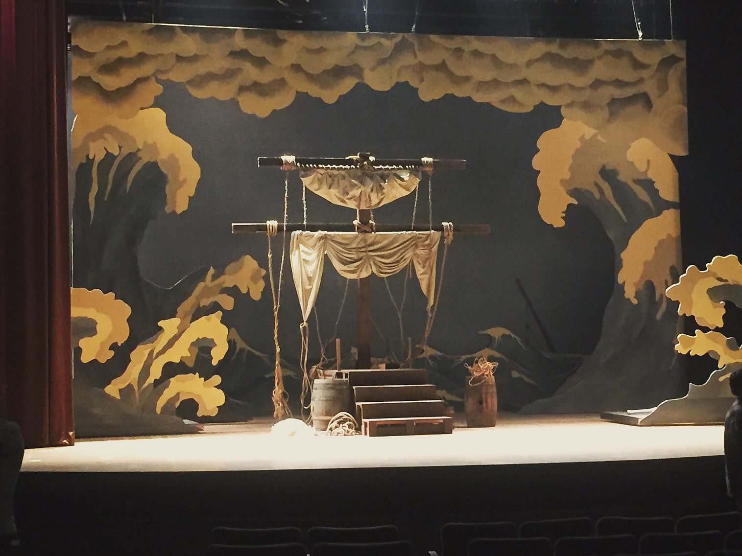 Theatrical stage set built for The Mad Whale, painted cloud backdrop behind a draped proscenium