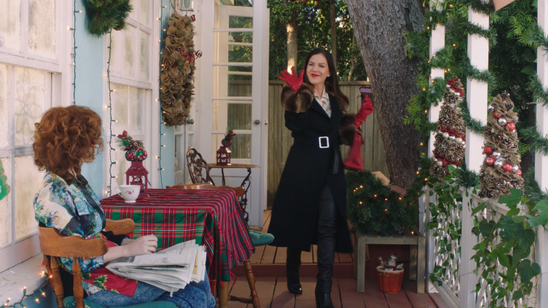 Decorated porch with a table and string lights, This Is Our Christmas