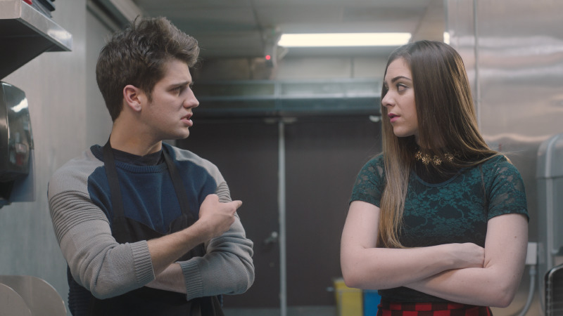 Two characters talking in a plain corridor, This Is Our Christmas